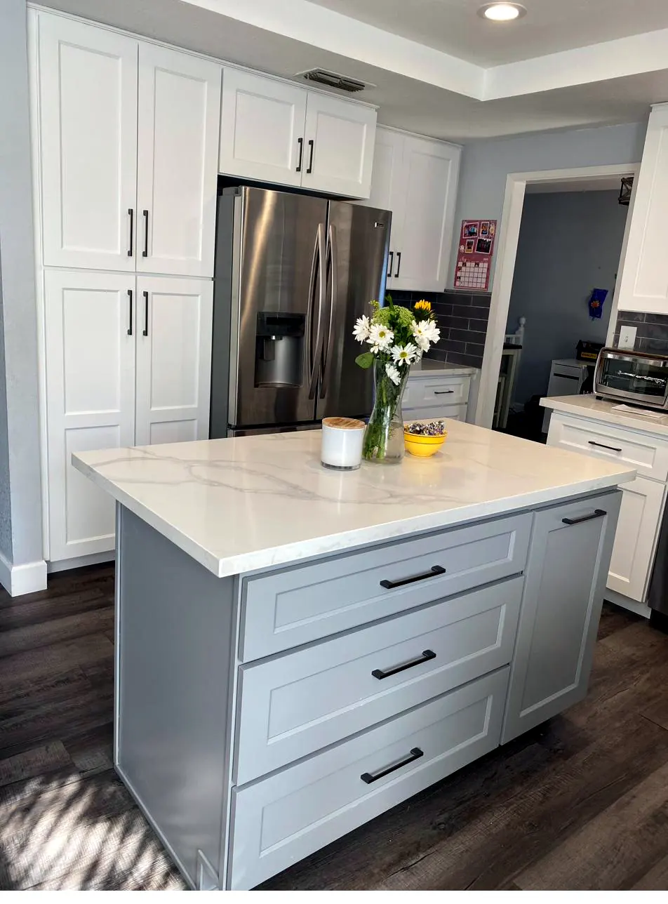 Completed two-tone kitchen remodel with white shaker perimeter and gray island
