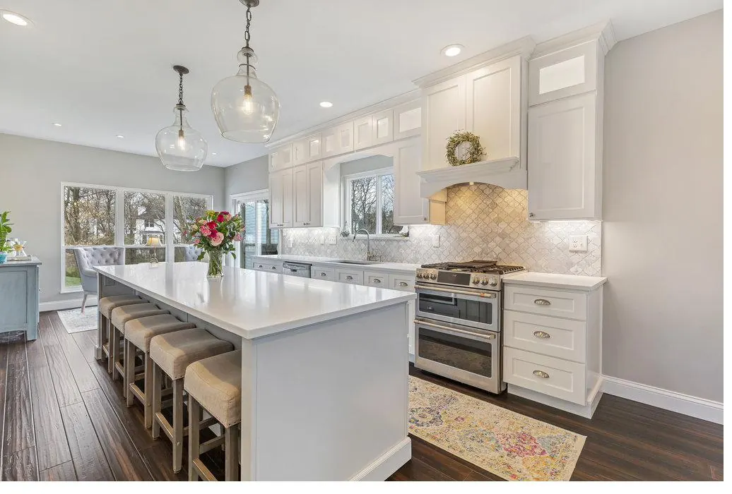Completed Twin Cities kitchen by ABC Cabinets & Design — white shaker cabinetry with marble backsplash