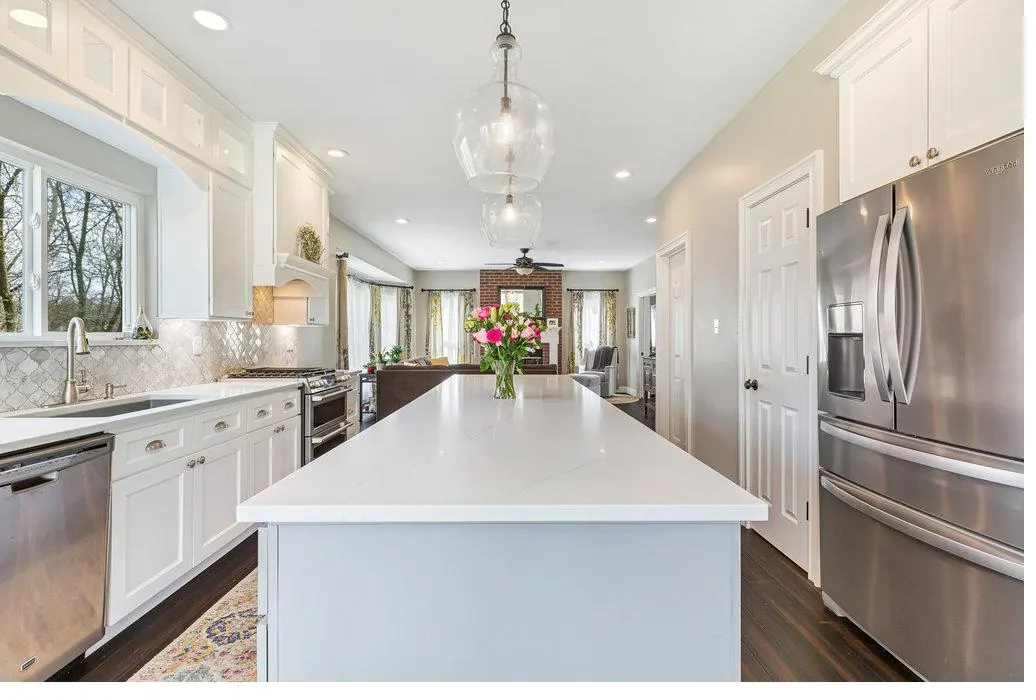 Completed kitchen with quartz island and arabesque marble backsplash